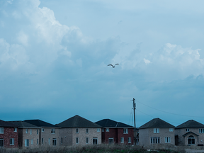 Dark clouds over a housing development