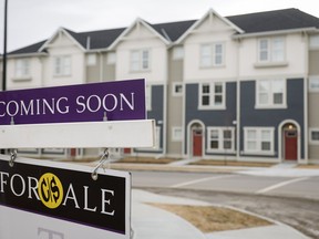 Houses for sale are shown in a new subdivision in Airdrie, Alta., Friday, Jan. 28, 2022. The Canadian Real Estate Association says seasonally adjusted home sales were down 3.3 per cent on a month-over-month basis in November.