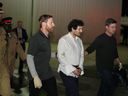 Sam Bankman-Fried, founder and former CEO of crypto currency exchange FTX, is walked in handcuffs to a plane during his extradition to the United States at Lynden Pindling international airport in Nassau, Bahamas Dec. 21, 2022.