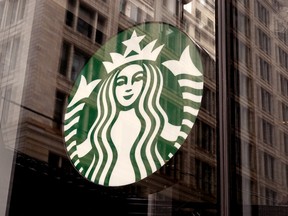 A Starbucks logo hangs in the window of one of the chain's coffee shops in Chicago.
