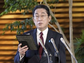 Japanese Prime Minister Fumio Kishida speaks before the media at his official residence in Tokyo, Tuesday, Dec. 27, 2022, after Kenya Akiba, minister in charge of reconstruction of Fukushima and other disaster-hit areas, submitted his resignation. Kishida on Tuesday dismissed his fourth minister in two months to patch a scandal-tainted Cabinet that has raised questions over his judgment of staff credentials.