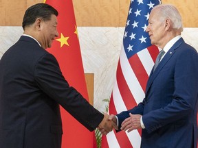 FILE - U.S. President Joe Biden, right, and Chinese President Xi Jinping shake hands before a meeting on the sidelines of the G20 summit meeting, on Nov. 14, 2022, in Bali, Indonesia. The U.S. Department of Commerce is adding 36 Chinese high-tech companies, including makers of aviation equipment, chemicals and computer chips, to an export controls blacklist, citing concerns over national security, U.S. interests and human rights.