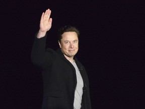 FILE - SpaceX's Elon Musk waves while providing an update on Starship, on Feb. 10, 2022, near Brownsville, Texas. Twitter on Thursday, Dec. 15, 2022, suspended the accounts of journalists who cover the social media platform and Musk, including reporters working for The New York Times, Washington Post, CNN and other publications