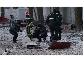 Police officers examine remains of a drone following an attack in Kyiv on Dec. 14. Photographer: Sergei Supinsky/AFP/Getty Images