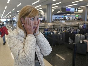 Chicago traveler Shana Schifer reacts after receiving her bags that had been lost since Christmas Day at the Southwest Airlines unclaimed baggage area at Salt Lake City International Airport Thursday, Dec. 29, 2022, in Salt Lake City. Southwest Airlines said it expects to return to normal operations Friday after slashing about two-thirds of its schedule in recent days, including canceling another 2,350 flights Thursday.