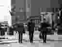 Pedestrians walk along Wall Street near the New York Stock Exchange.