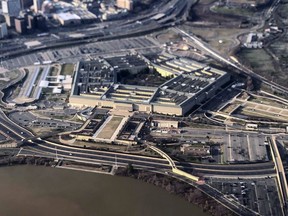 FILE - The Pentagon is seen in this aerial view made through an airplane window in Washington, Jan. 26, 2020. Google, Oracle, Microsoft and Amazon will share in the Pentagon's $9 billion contract to build its cloud computing network. The announcement comes a year after accusations of politicization over the previously announced contract and a protracted legal battle resulted in the military starting over in its award process.