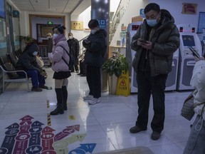 Visitors stand in the waiting area of a community health clinic in Beijing, Thursday, Dec. 15, 2022. A week after China eased some of the world's strictest COVID-19 containment measures, uncertainty remains over the direction of the pandemic in the world's most populous nation.