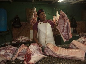 A meat vendor sells pork at a private market in Havana, Cuba, Friday, Dec. 23, 2022.