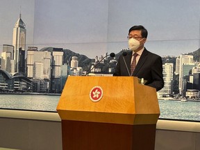 Hong Kong Chief Executive John Lee speaks to reporters at his weekly press briefing in Hong Kong Tuesday, Dec. 20, 2022. Lee will meet China's President Xi Jinping to report on the city's political, economic and pandemic control situation during his maiden duty visit in Beijing this week.