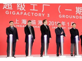 Tom Zhu, left, with Elon Musk, center, at the groundbreaking of Tesla's Shanghai factory in January 2019. Photographer: Qilai Shen/Bloomberg