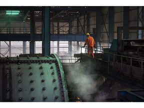 A worker stands next to machinery in the mineral selection shop at the Dongguashan Copper Mine, operated by Tongling Nonferrous Metals Group Co., in Tongling, Anhui province, China, on Thursday, Jan. 17, 2019. On the heels of record refined copper output last year, China's No. 2 producer, Tongling, says it'll defy economic gloom and strive to churn out even more of the metal in 2019. Photographer: Qilai Shen/Bloomberg