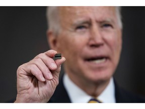 WASHINGTON, DC - FEBRUARY 24: U.S. President Joe Biden holds a semiconductor during his remarks before signing an Executive Order on the economy in the State Dining Room of the White House on February 24, 2021 in Washington, DC.