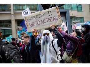 Climate activists hold signs during a