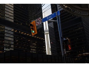 The CN Tower from Bay Street In the financial district in Toronto, Ontario, Canada, on Monday, Nov. 22, 2021. Many of Canada's large financial firms say they have a growing portion of their workforces back in the office and the numbers are expected to swell in the New Year. Photographer: Cole Burston/Bloomberg