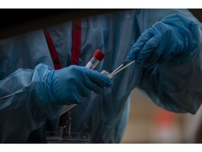 A healthcare worker prepares a Covid-19 swab test at the Boulder County Fairgrounds testing site in Longmont, Colorado, U.S., on Tuesday, Dec. 14, 2021. The omicron variant now makes up 3% of all sequenced Covid-19 cases in the U.S., rising from less than 0.1% in early December, health officials said, a sign of the rapid spread of the new coronavirus version.
