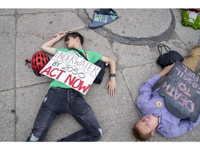 Extinction Rebellion demonstrators during a die-in for climate change in Boston, Massachusetts, US, on Tuesday, July 5, 2022. A deeply divided US Supreme Court dealt a major blow to President Joe Bidens climate-change agenda, restricting the Environmental Protection Agencys ability to curb power-plant emissions and saying Congress would have to act to give the agency more authority.