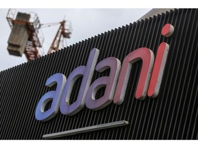 Signage of Adani Group at company's residential building under construction in Mumbai, India, on Tuesday, Sep. 6, 2022. Adani Group, indirectly acquired a 29.2% stake in New Delhi Television Ltd., or NDTV, and offered to buy another 26% from the open market for a combined 6.07 billion rupees ($76 million) in August 2022. Photographer: Dhiraj Singh/Bloomberg
