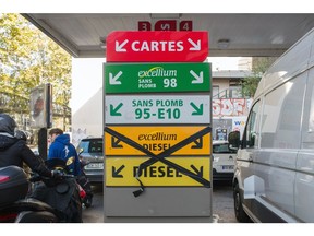 A sign indicates that diesel is unavailable as customers queue for fuel at a TotalEnergies SE gas station in Paris, France, on Friday, Oct. 7, 2022. The French government may release additional strategic fuel stocks to ease shortages caused by a refinery strike that has drained gas stations in some regions.