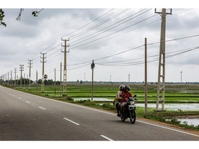 Wind turbines and electricity towers along Navathkuli-Karativu-Mannar Highway connecting Pooneryn Peninsula and Jaffna district in Jaffna district, Sri Lanka, on Monday, Oct. 24, 2022. Northern Sri Lanka, an impoverished, remote area within striking distance of India's southern tip is where Gautam Adani -- the Indian billionaire who is Asia's richest man plans to build renewable power plants, thrusting him into the heart of an international political clash. Photographer: Jonathan Wijayaratne/Bloomberg