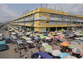 Vendors stalls set up under umbrellas for protection from the sun at the Kaneshie Market Complex in Accra, Ghana, on Wednesday, Nov. 30, 2022. With debt interest payments eating up more than half of government revenues Ghana has asked the IMF for a $3 billion bailout, proposed a debt restructuring that could involve losses of up to 30% for foreign investors and is planning to barter some of the gold it produces for oil.