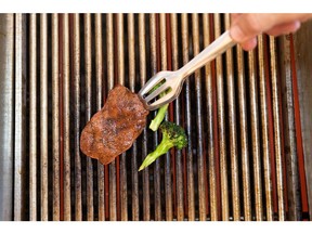A chef grills a piece of cultivated thin-cut steak in the Aleph Farms Ltd. development kitchen in Rehovot, Israel, on Sunday, Nov. 27, 2022. The UN predicted last year that with the world's population expected to climb by 11% in the coming decade, meat consumption would rise by an even greater 14%.