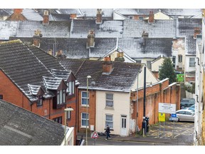 Snow-covered roofs on terraced houses in Aldershot, UK, Monday, Dec. 12, 2022. UK power prices for Monday jumped to record levels as freezing temperatures are set to cause a surge in demand, just as a drop in wind generation causes a supply crunch.