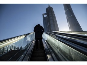 A pedestrian in the Lujiazui Financial District in Shanghai, China, on Tuesday, Dec. 20, 2022. China appears to be seeing an increase in Covid deaths across a swath of the country that aren't being reported in government figures, according to social media posts, adding to speculation that officials are masking the full impact of their abrupt shift away from Covid Zero. Photographer: Qilai Shen/Bloomberg