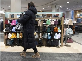A shopper in a clothing store in Montreal. Photographer: Christinne Muschi/Bloomberg