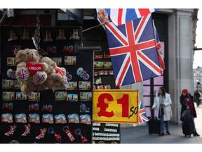 LONDON, ENGLAND - JANUARY 02: An altered £1 sign at a souvenir stall on January 2, 2023 in London, England. 2023 predictions will see inflation in the UK fall but continued rising energy prices fueling a cost of living crisis will mean the UK's recession may last longer than first thought.