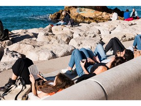 Visitors sit in the sun at Corniche Kennedy in Marseille, France, on Thursday, Jan. 5, 2023. Europe is set for the warmest January in years, easing an energy crunch that has hammered the region for months.