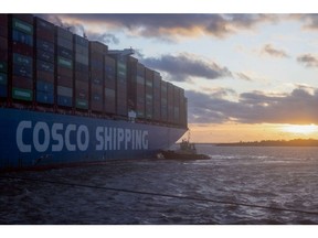 A tugboat operated by Svitzer A/S assists the CSCL Arctic Ocean container ship, operated by China Ocean Shipping Group Co. (COSCO), as it arrives at the Port of Felixstowe, owned by a unit of CK Hutchison Holdings Ltd., in Felixstowe, UK, on Friday, Jan. 13, 2023. Britain's trade deficit narrowed sharply after a slump in natural gas prices reduced import costs and a flurry of exports of aircraft and cars. Photographer: Chris Ratcliffe/Bloomberg