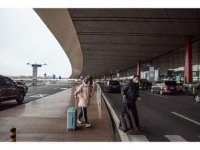 Travelers with their luggage at Beijing Capital International Airport in Beijing, China, on Saturday, Jan. 14, 2023. There are growing concerns that this month's Lunar New Year holiday will see Covid sweep through smaller cities and rural areas as hundreds of thousands of people travel home, with many finally able to reunite with family after three years. Bloomberg