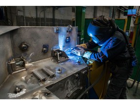 An employee welds a section of an Arquus armored vehicle on the maintenance line at the Arquus Garchizy plant, a unit of Volvo AB, in Garchizy, France, on Monday, Jan. 16, 2023. Photographer: Nathan Laine/Bloomberg