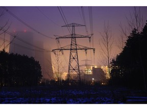 High voltage electricity transmission towers on snow-covered terrain near the Jaenschwalde lignite-fired Power Station, operated by Lausitz Energy Bergbau AG (LEAG), in Peitz, Germany, on Tuesday, Jan. 24, 2023. Across the globe, highly polluting -- and relatively cheap -- coal is making a comeback as governments seek to prevent soaring energy costs from upending economies and destabilizing governments already grappling with high inflation. Photographer: Krisztian Bocsi/Bloomberg
