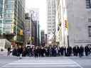 Pedestrians in Toronto's financial district.  Despite our many assets, Canada's economic growth has been mediocre.