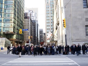 Pedestrians in Toronto's financial district. Despite our many advantages, Canada's economic growth has been middling.