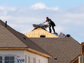 A construction worker on top of a roof