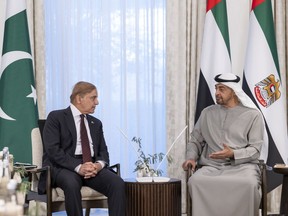 In this handout photograph from the United Arab Emirates' Presidential Court, Pakistan's Prime Minister Shahbaz Sharif, left, meets with Emirati leader and Abu Dhabi ruler Sheikh Mohammed bin Zayed Al Nahyan at Al Shati Palace in Abu Dhabi, United Arab Emirates, Thursday, Jan. 12, 2023. Pakistan's prime minister said Thursday that the United Arab Emirates agreed to extend a $2 billion loan to his country and provide an additional $1 billion as his nation struggles to recover from devastating floods this summer.