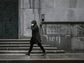 A pedestrian passes the Bank of Canada building in Ottawa.
