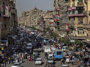 FILE - People crowd a street a few hours ahead of curfew in Cairo, Egypt, Tuesday, April 14, 2020. Egypt continues to battle surging inflation amid a dramatic slide of its currency as many Egyptians struggle with price hikes, the country's statistics bureau said Tuesday, Jan. 10, 2023.
