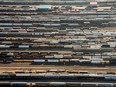 Freight trains and oil tankers sit in a rail yard in this aerial photograph taken above Toronto. Canada's trade balance swung into deficit in November, a sign, economists say, of weakening demand.