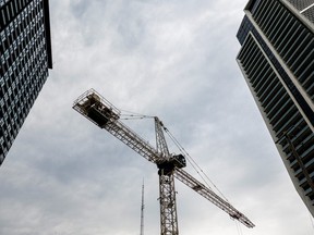 A crane stands between condo buildings in Toronto.