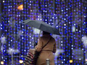 A pedestrian walks past festive lighting in Toronto, in December.