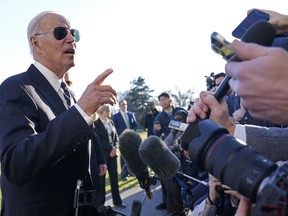 President Joe Biden talks with reporters on the South Lawn of the White House in Washington, Monday, Jan. 30, 2023, after returning from an event in Baltimore on infrastructure.