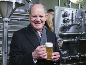 German Chancellor Olaf Scholz holds a glass of beer during his visit to the Gold Ochsen brewery in Ulm, Germany, Monday, Jan. 16, 2023.