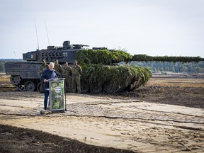 FILE - German Chancellor Olaf Scholz speaks to soldiers in front of a Leopard 2 main battle tank after the Army's training and instruction exercise in Ostenholz, Germany, Monday, oct. 17, 2022. Germany has become one of Ukraine's leading weapons suppliers in the 11 months since Russia's invasion. The debate among allies about the merits of sending battle tanks to Ukraine has focused the spotlight relentlessly on Germany, whose Leopard 2 tank is used by many other countries and has long been sought by Kyiv.