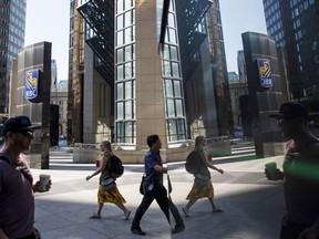 Pedestrians in Toronto's financial district. Despite our many advantages, Canada's economic growth has been middling.