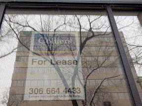 A for lease sign is displayed in the window of a vacant office building in Saskatoon.