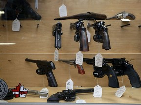 A selection of hand guns on display at an Ottawa store in June, 2022, shortly after Prime Minister Justin Trudeau announced a proposed freeze on sales in the wake of recent mass shootings in the U.S.